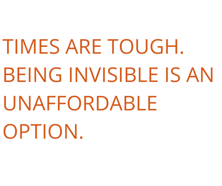 Text graphic reading "Times are tough. Being invisible is an unaffordable option." over a blurred desk scene with a coffee cup and laptop.
